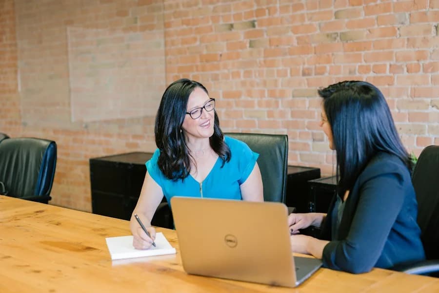 Two colleagues meeting to discuss their work